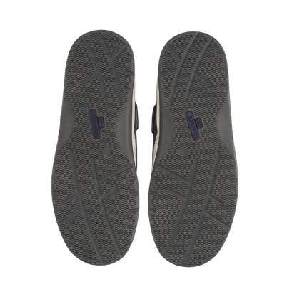 Gray shoe soles with a brand logo on a black background