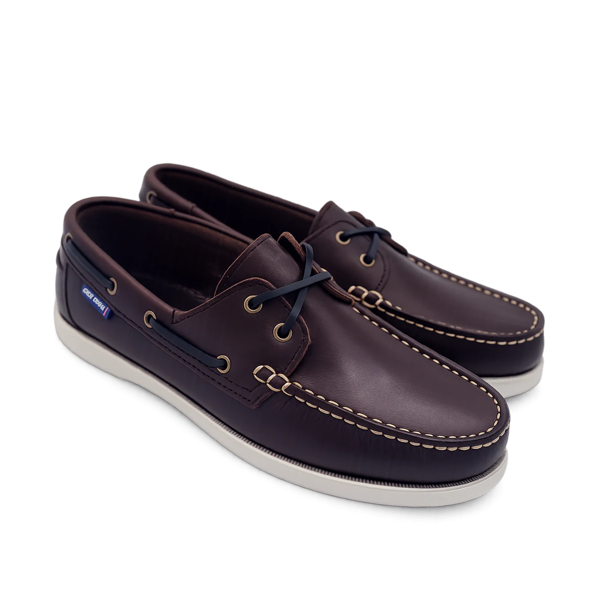 Pair of brown leather shoes with white soles on a white background deck shoes boat shoes
