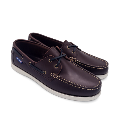 Pair of brown leather shoes with white soles on a white background deck shoes boat shoes
